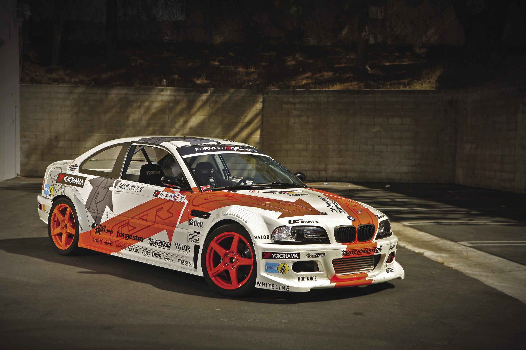 Yellow BMW M3 E36 fully sideways in a huge cloud of tire smoke at Tor Stadion Slaski during Drift Masters Poland 2023