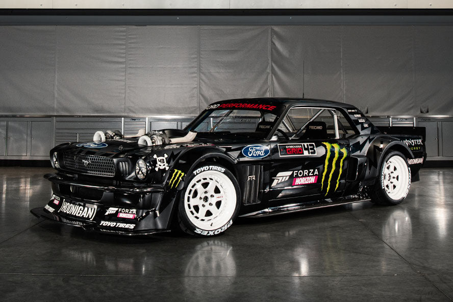 Ken Block's twin-turbo Hoonicorn Mustang and Mad Mike's RX-7 trading drifts at the Goodwood Festival of Speed hillclimb