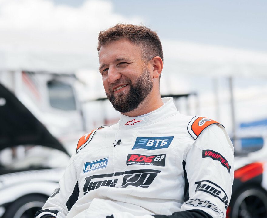 Artem Shabanov smiling in the pit next to the TimeUp Supra