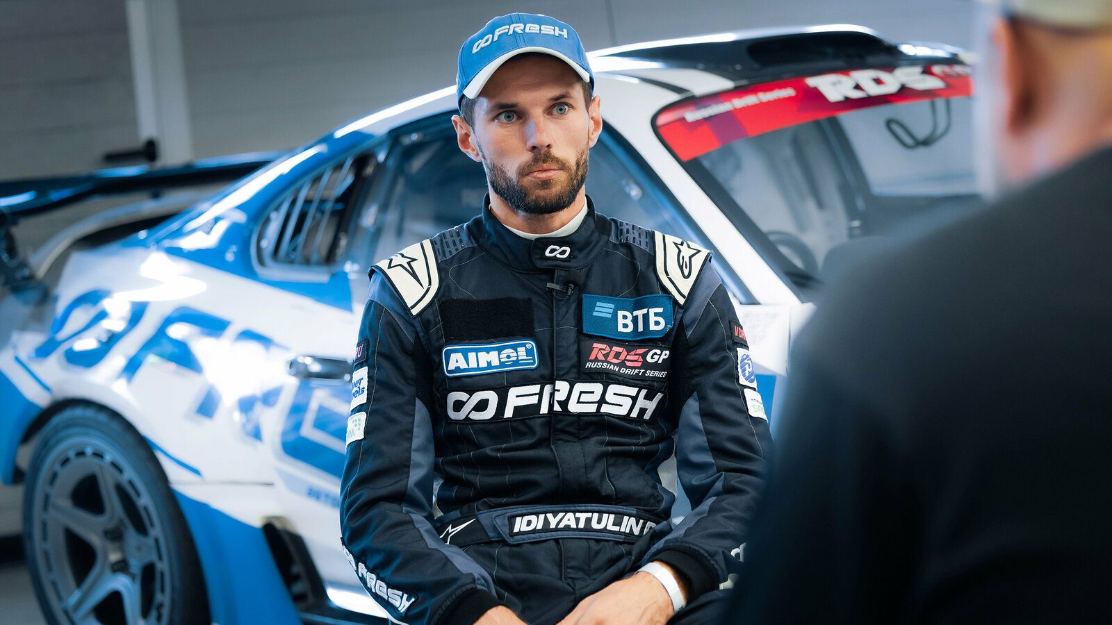Damir Idiyatulin in his Fresh Racing suit, seated in the pit at RDS GP