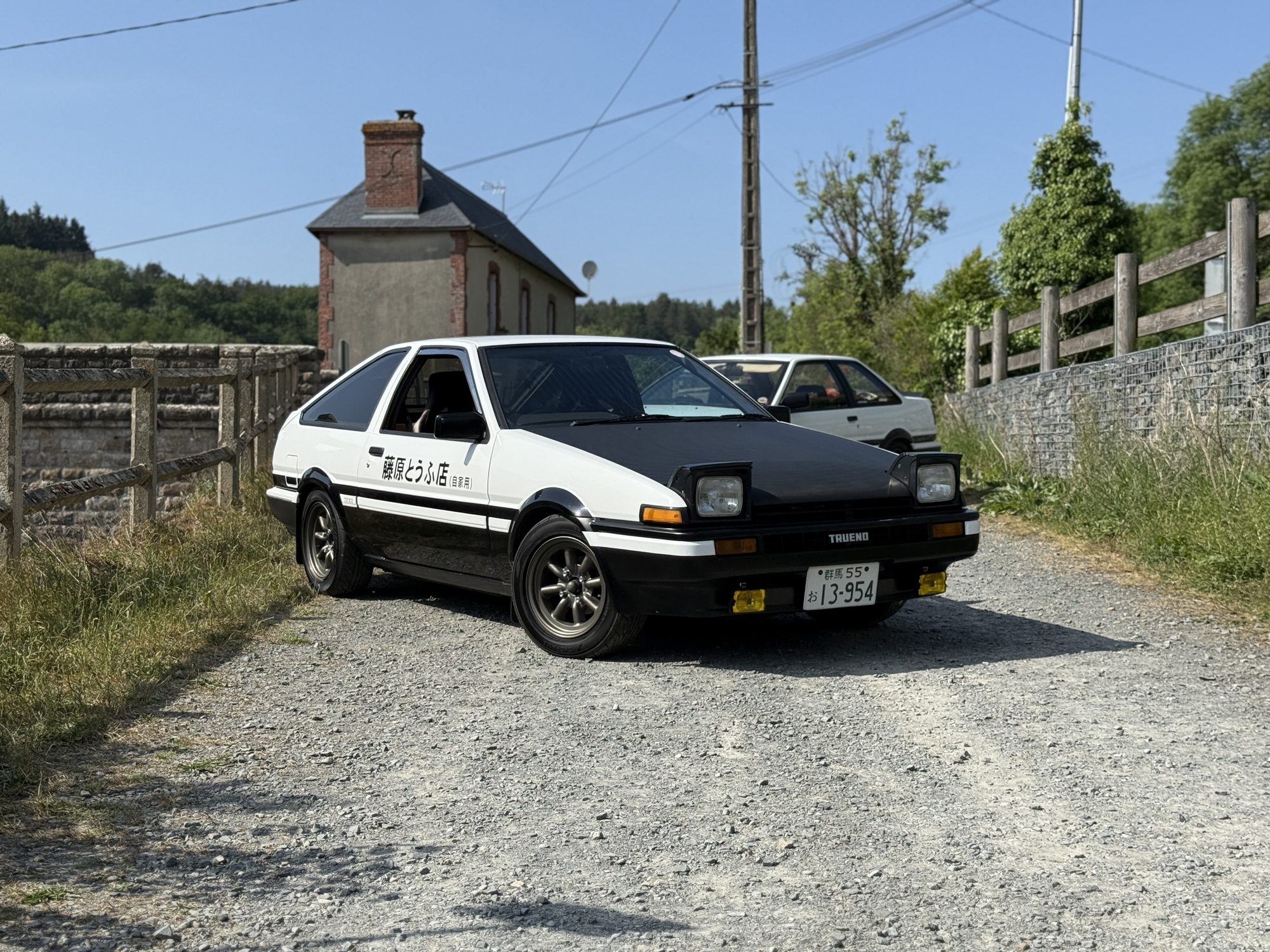 Toyota Sprinter Trueno AE86 in the Initial D tofu-shop livery on a mountain road