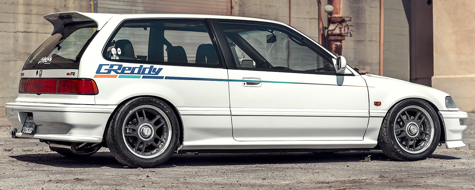 White Honda Civic EF hatch in GReddy livery, side profile